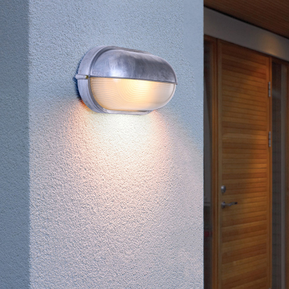 Estwin outdoor wall light fitted beside a doorway on a rendered exterior wall
