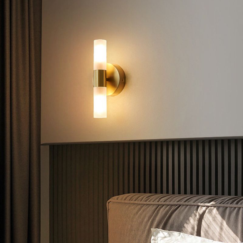 Brenlo wall light glowing warm above a fluted headboard in a bedroom