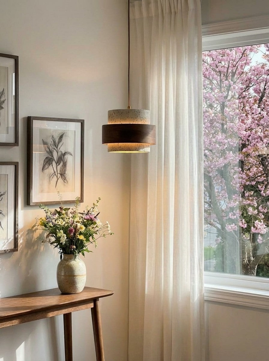 Trava pendant light switched on, casting warm light in a bright hallway corner