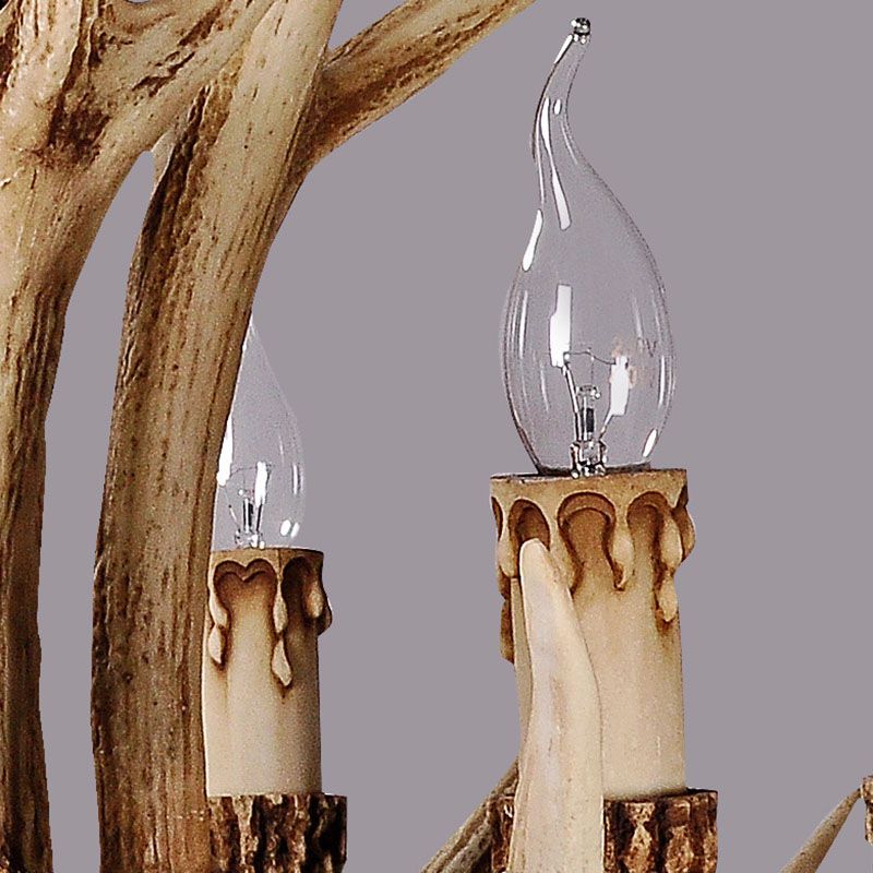 Detail of candle-shaped bulbs and textured antler branches on the Stagra chandelier