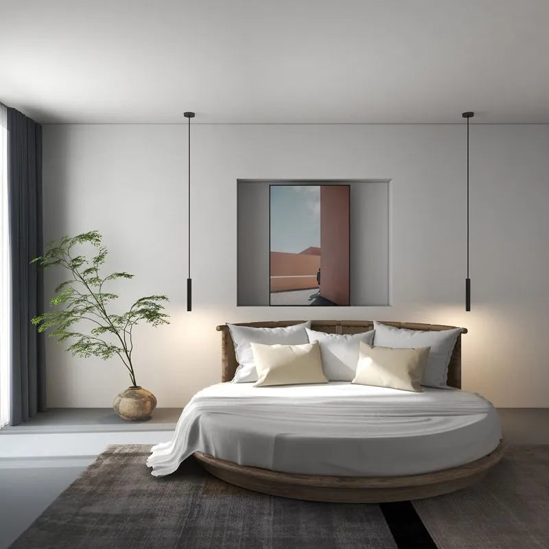 Filon Slim Linear Pendant Light hung as a pair above a round bed in a neutral room