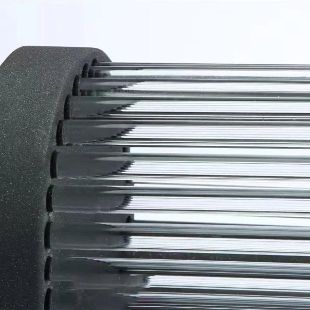 Close detail of the fluted glass rods and black metal frame of the Yoro outdoor wall light