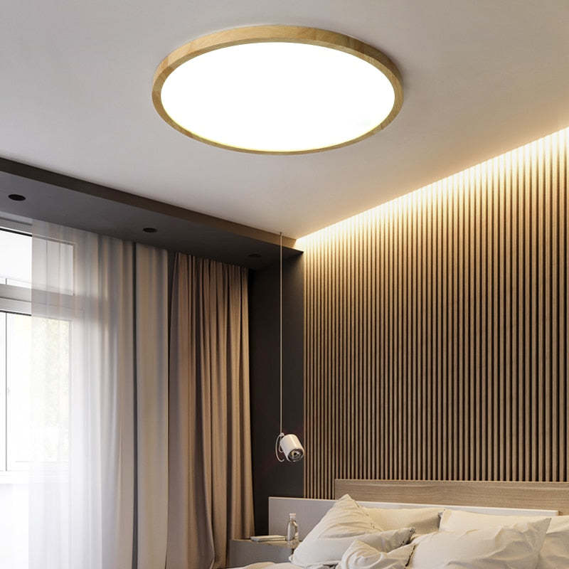 Aveno round flush mount light glowing warm in a slatted timber bedroom