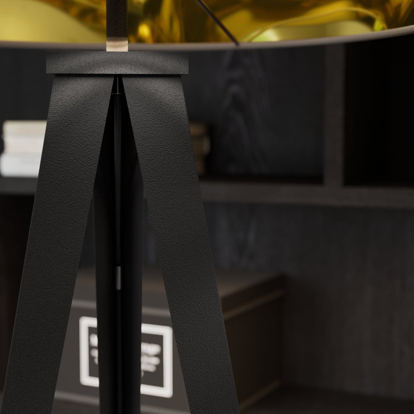 Close-up of the Beno floor lamp tripod joint where the three textured black legs meet beneath the shade