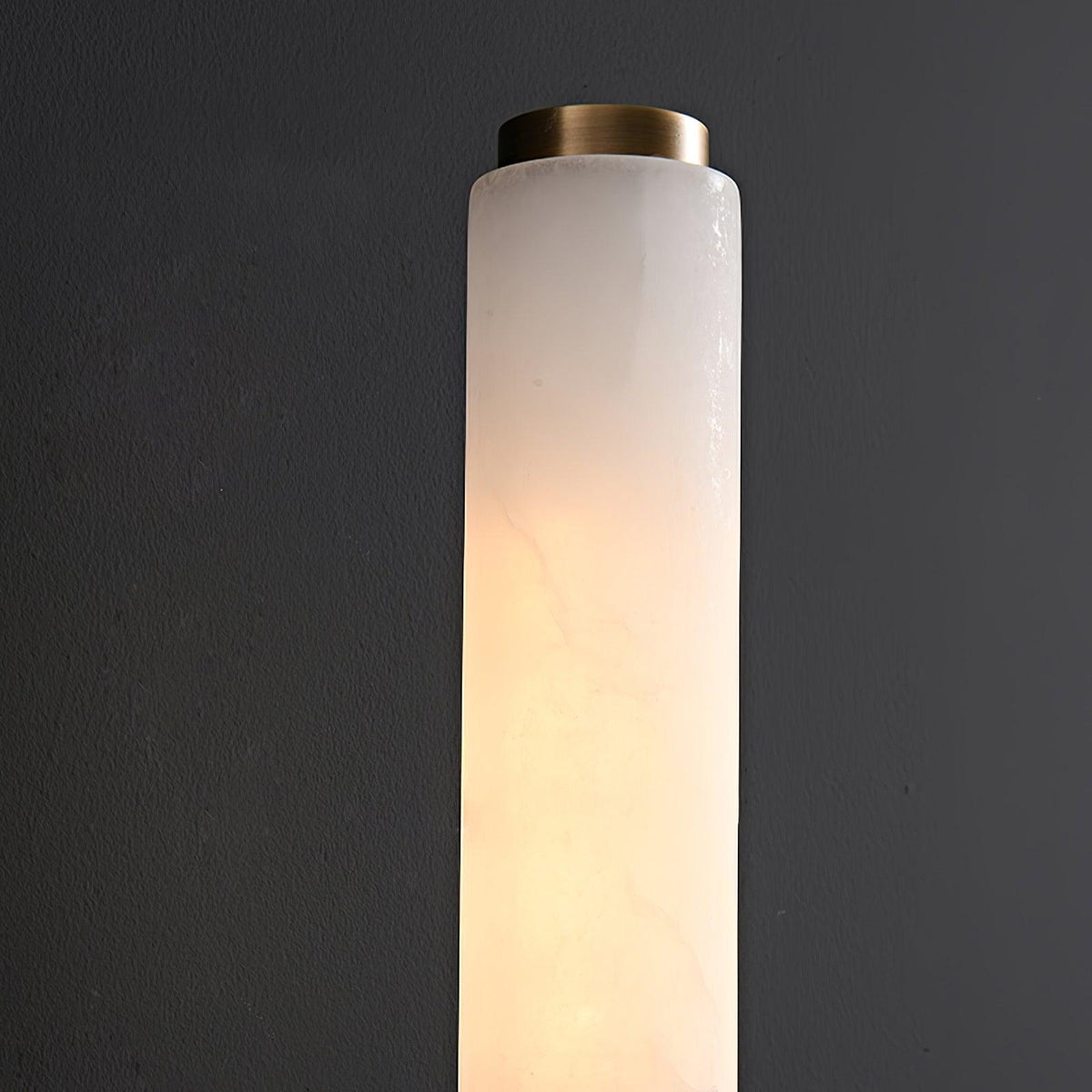 Detail of the natural alabaster shade and brass collar on the Jerno wall light