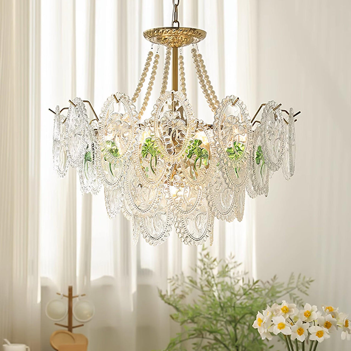 Delvi chandelier lit in a pale room, casting patterned light through the pressed glass plaques