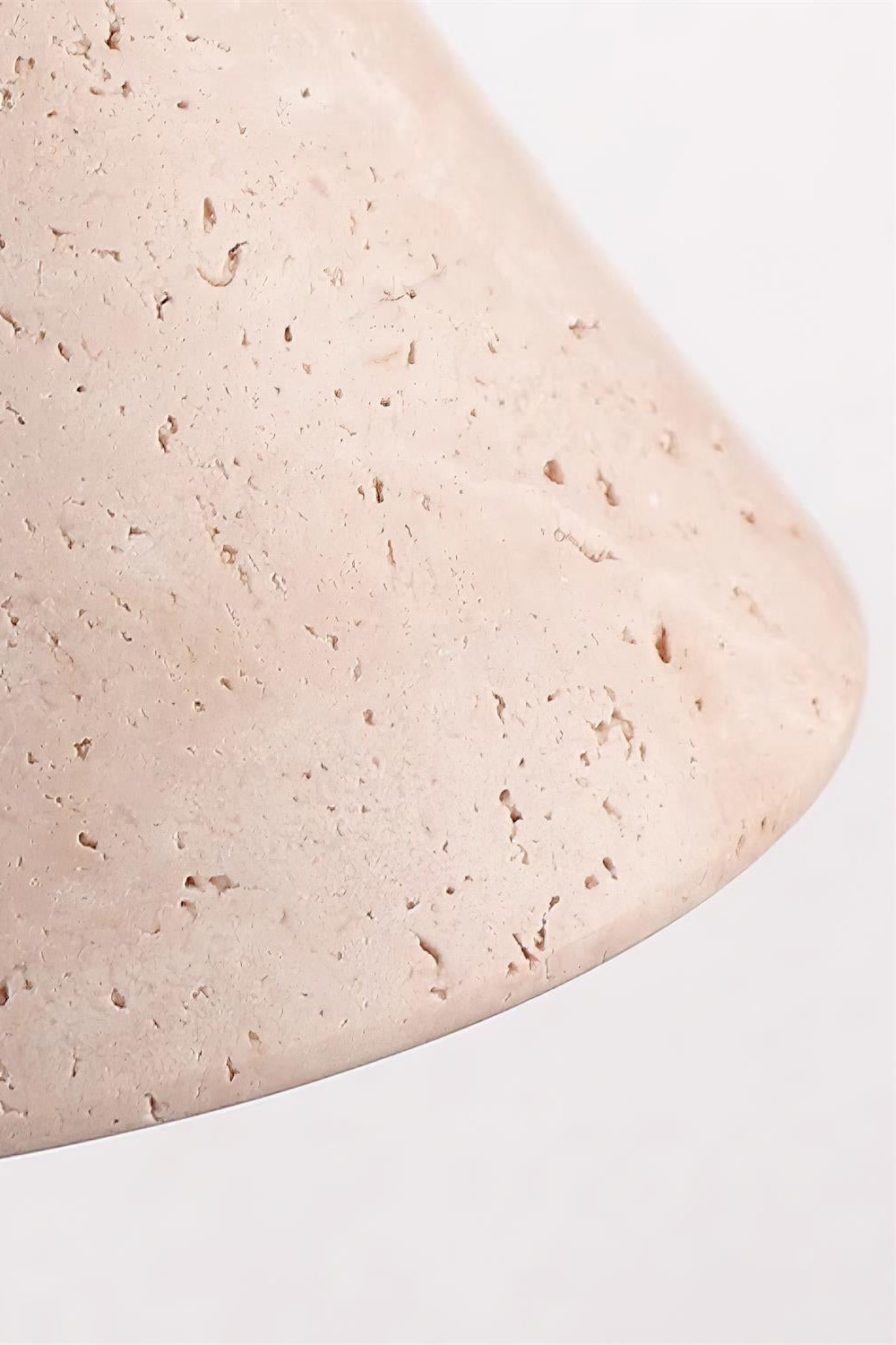Close view of the open pores and banding in the travertine cone of the Marlo wall light
