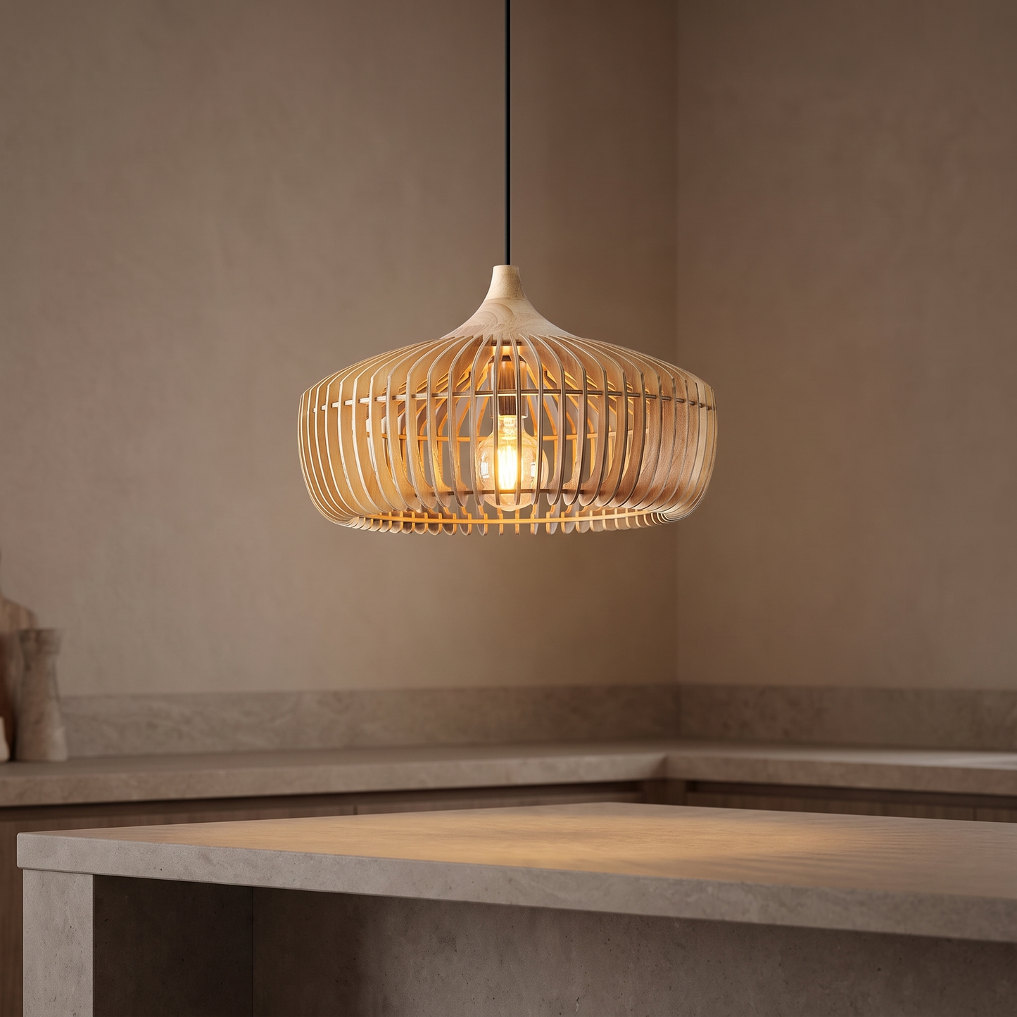 Muno slatted wood pendant light lit above a stone kitchen island in a warm neutral kitchen