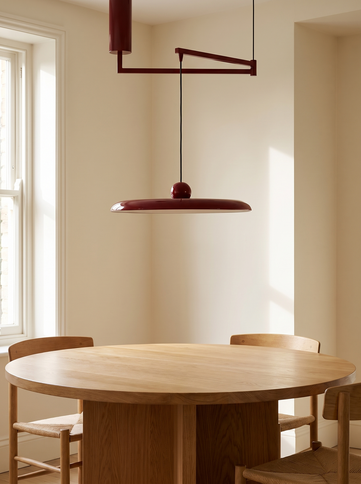 Fluxa Morandi Arm Pendant Light - scale context over round oak dining table with chairs