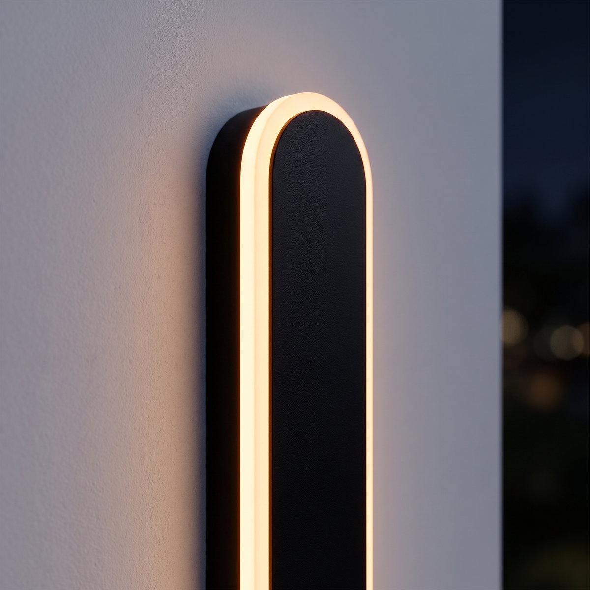 Orvo Linear Oval Outdoor Wall Light - macro close-up of rounded top end cap with warm amber LED glow