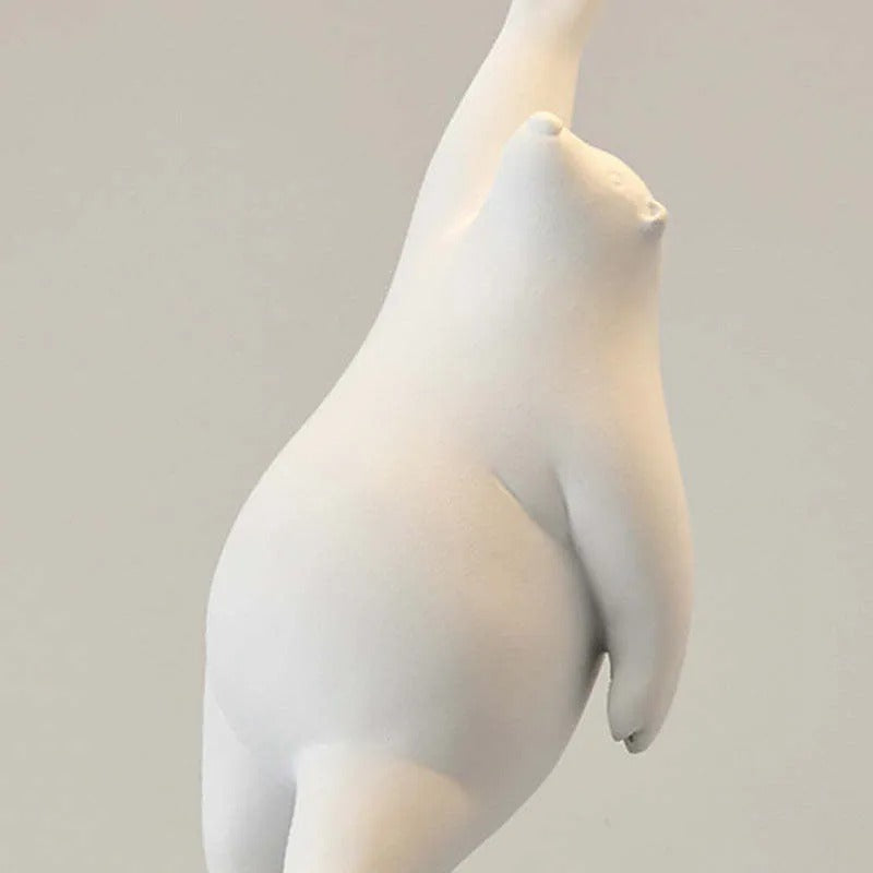 Close view of a moulded white resin bear hanging from the balloon cord of the Wisto ceiling light