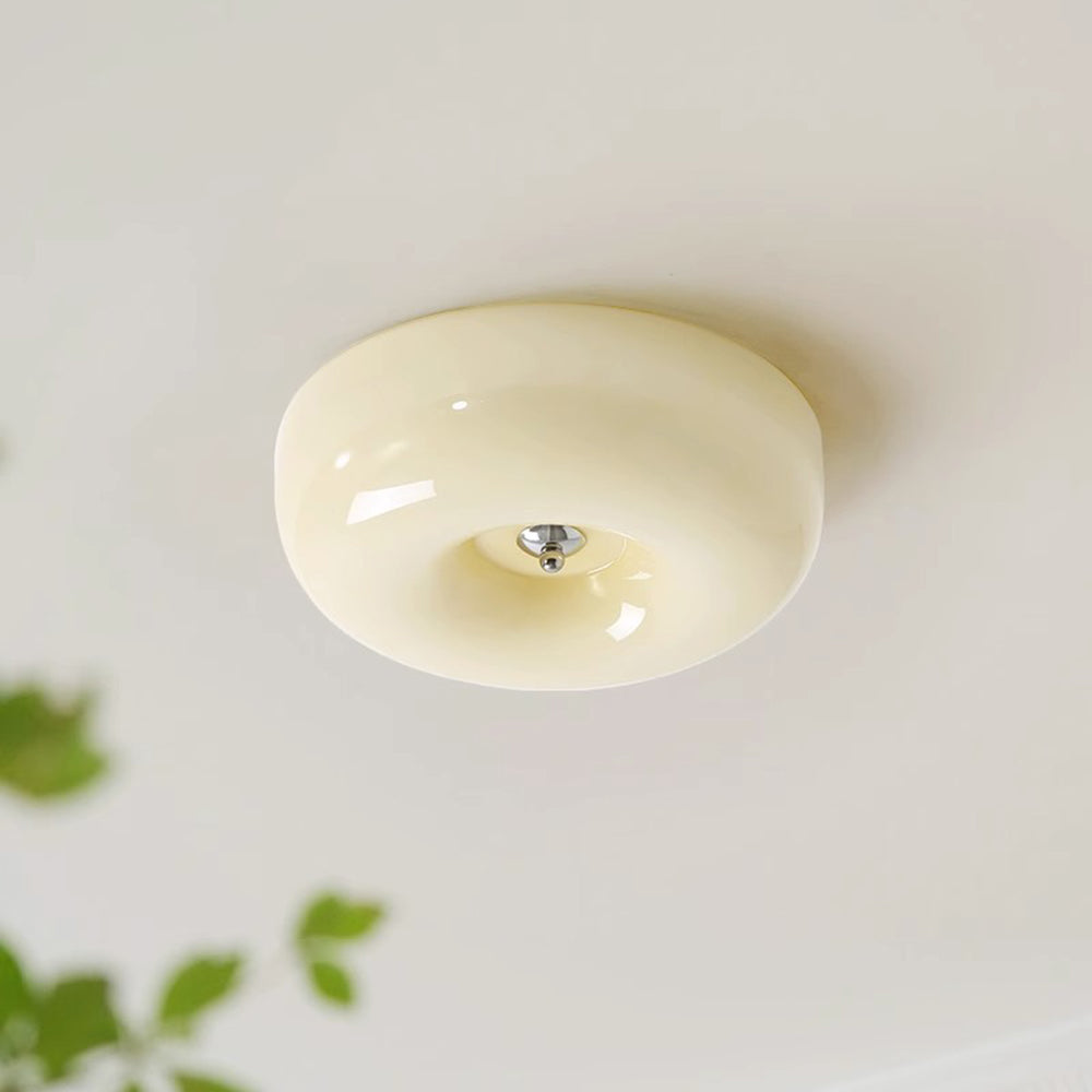 Cando Cream Glass Ceiling Light lit softly on a pale ceiling