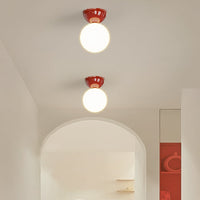 Two red Vellona Petite ceiling lights fitted along a bright hallway ceiling