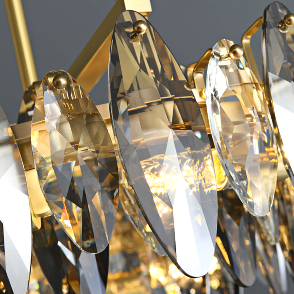 Close view of the Ondra chandelier showing faceted teardrop crystals set on the gold frame