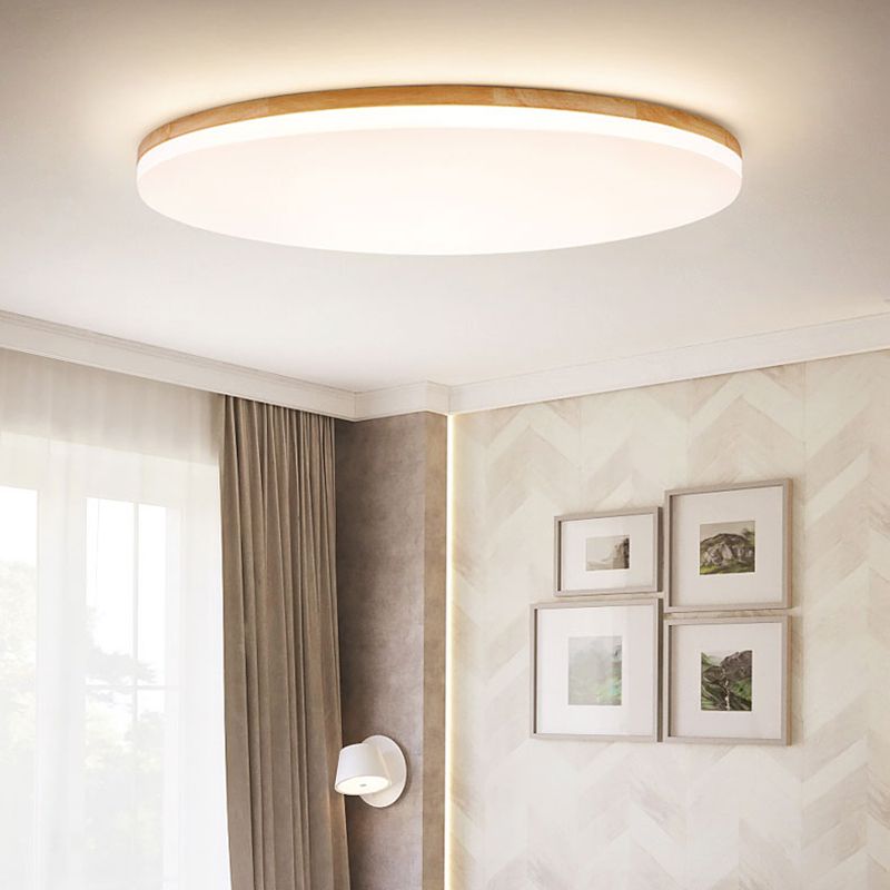 Nolla flush mount ceiling light in a bedroom with textured wall panelling and framed prints