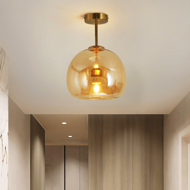Belvo ceiling light mounted on a white hallway ceiling casting warm amber light