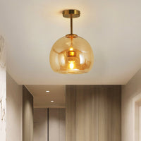 Belvo ceiling light mounted on a white hallway ceiling casting warm amber light