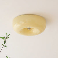 Cando Cream Glass Ceiling Light with a trailing green plant in the foreground