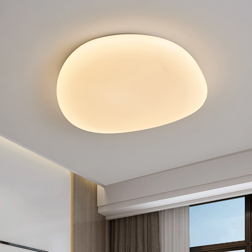 Close view of the Sayen ceiling light showing the even glow across the pebble diffuser
