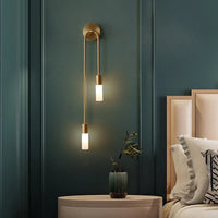 Vano gold wall sconce beside bed in teal bedroom