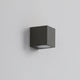 Dovra square outdoor wall light in black mounted on a plain grey wall, compact cube with a recessed lens underneath