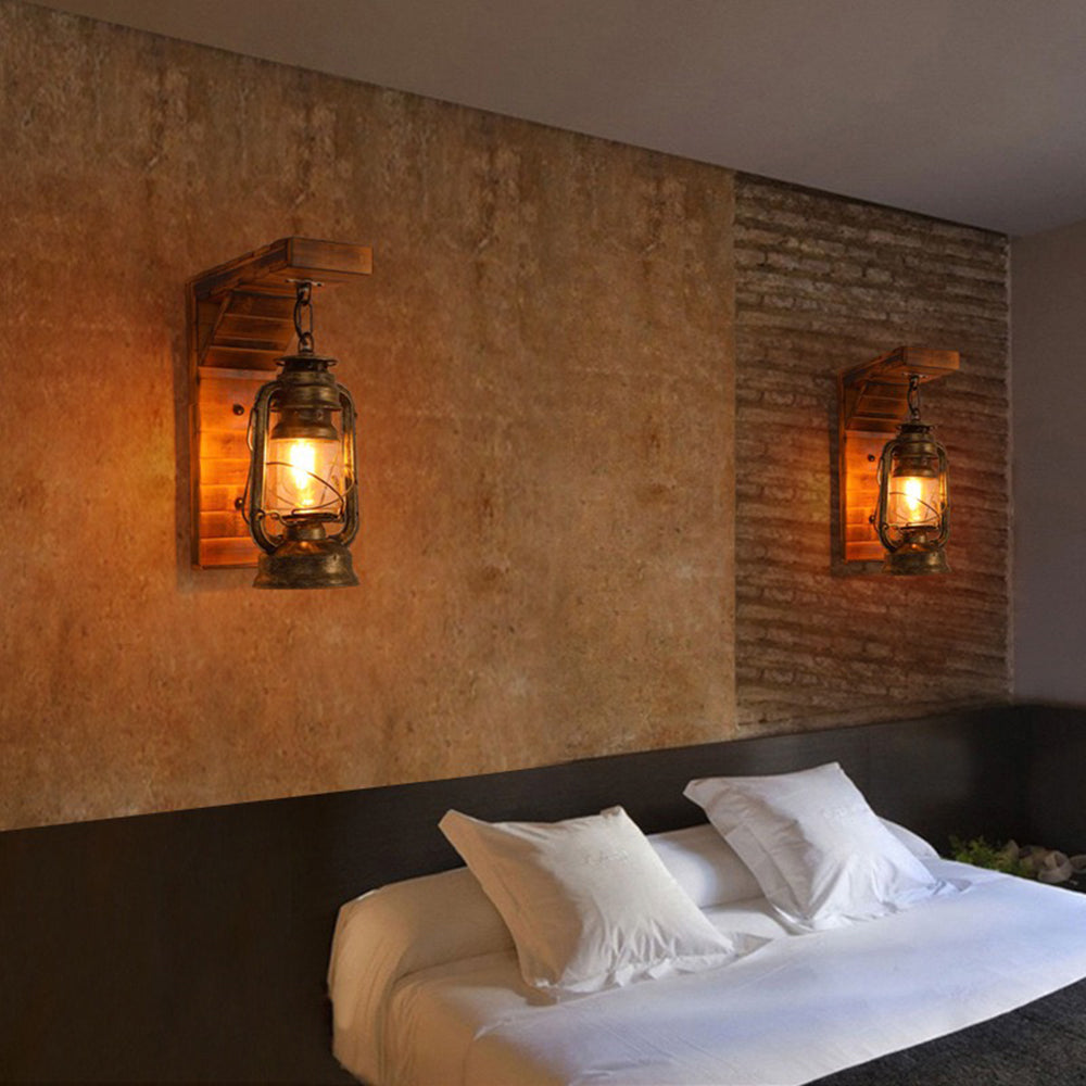 Kenva lantern wall light lit on a warm plaster wall above a side table and armchair