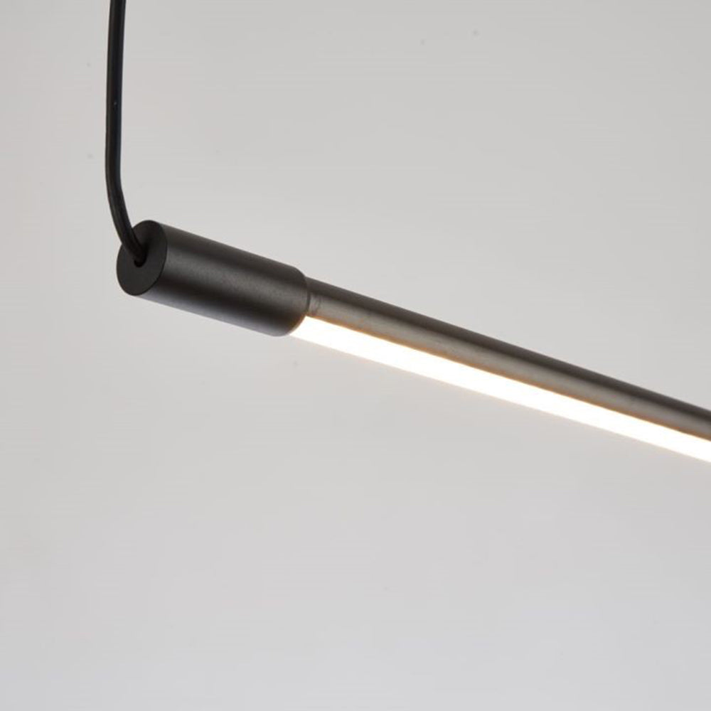 Close view of the Zyno Linear Pendant Light end cap showing the matt black finish and lit diffuser