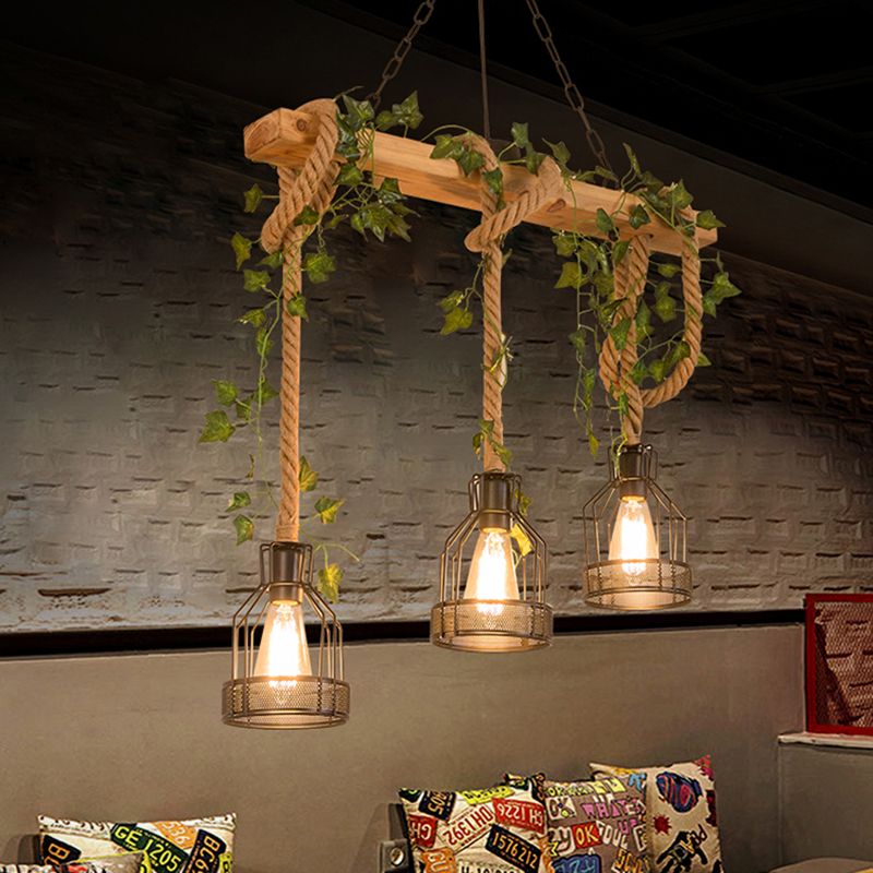 Three cage lanterns of the Verdow pendant light lit above a seating booth