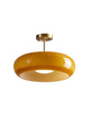 Bardo brass and amber glass disc ceiling light on a plain white background