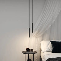 Filon Slim Linear Pendant Light hanging beside a bed next to sheer curtains
