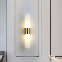 Fela twin glass wall sconce in panel hallway