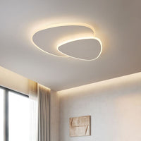 Brindo ceiling light lit warm white on a bedroom ceiling beside a curtained window