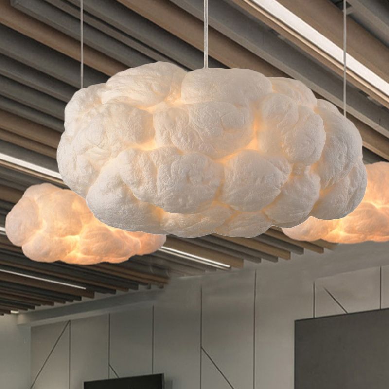 Nuvo cotton cloud pendant lights suspended below a slatted timber ceiling in a bright open room