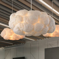 Nuvo cotton cloud pendant lights suspended below a slatted timber ceiling in a bright open room