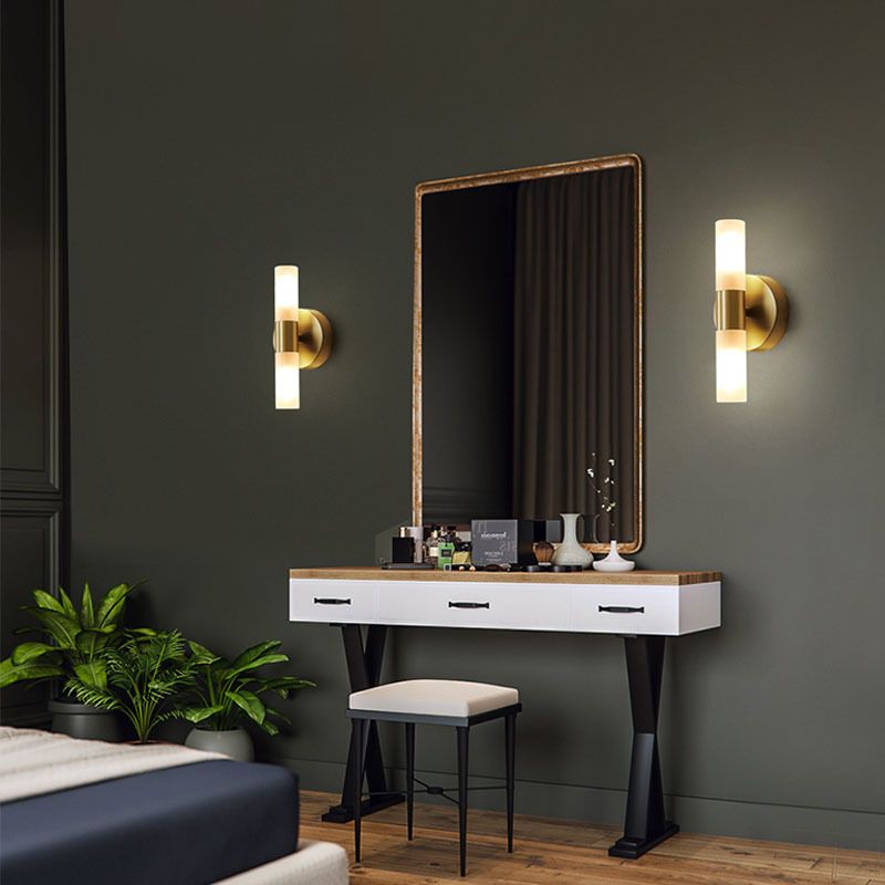 Pair of Brenlo brass wall lights flanking a mirror above a dressing table