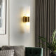 Fela wall sconce in living room warm brass finish