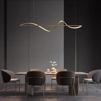 Kavro gold wave pendant light above a long dining table in a dark panelled room