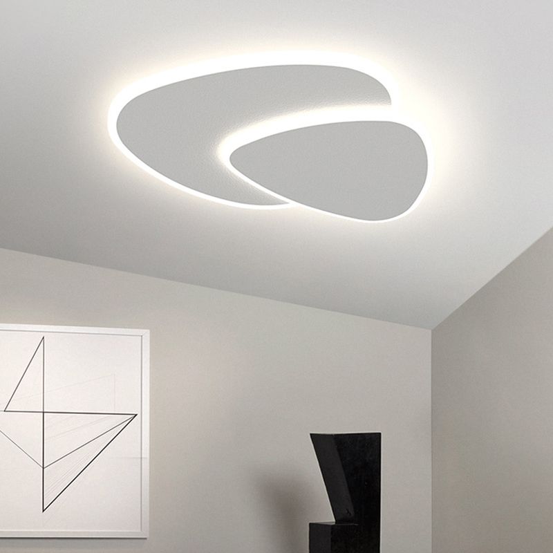 Brindo flush mount ceiling light fitted on a sloped white ceiling in a minimal room