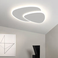 Brindo flush mount ceiling light fitted on a sloped white ceiling in a minimal room