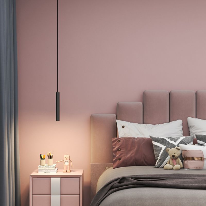 Filon Slim Linear Pendant Light hanging beside a bed above a bedside table