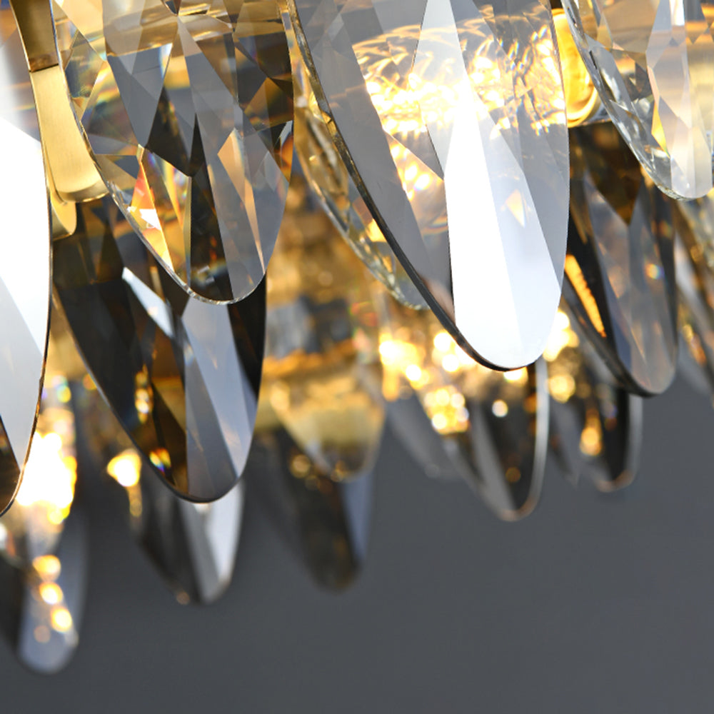 Detail of the clear and smoke-tinted crystal tiers on the lit Ondra chandelier
