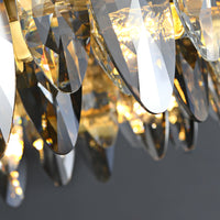Detail of the clear and smoke-tinted crystal tiers on the lit Ondra chandelier