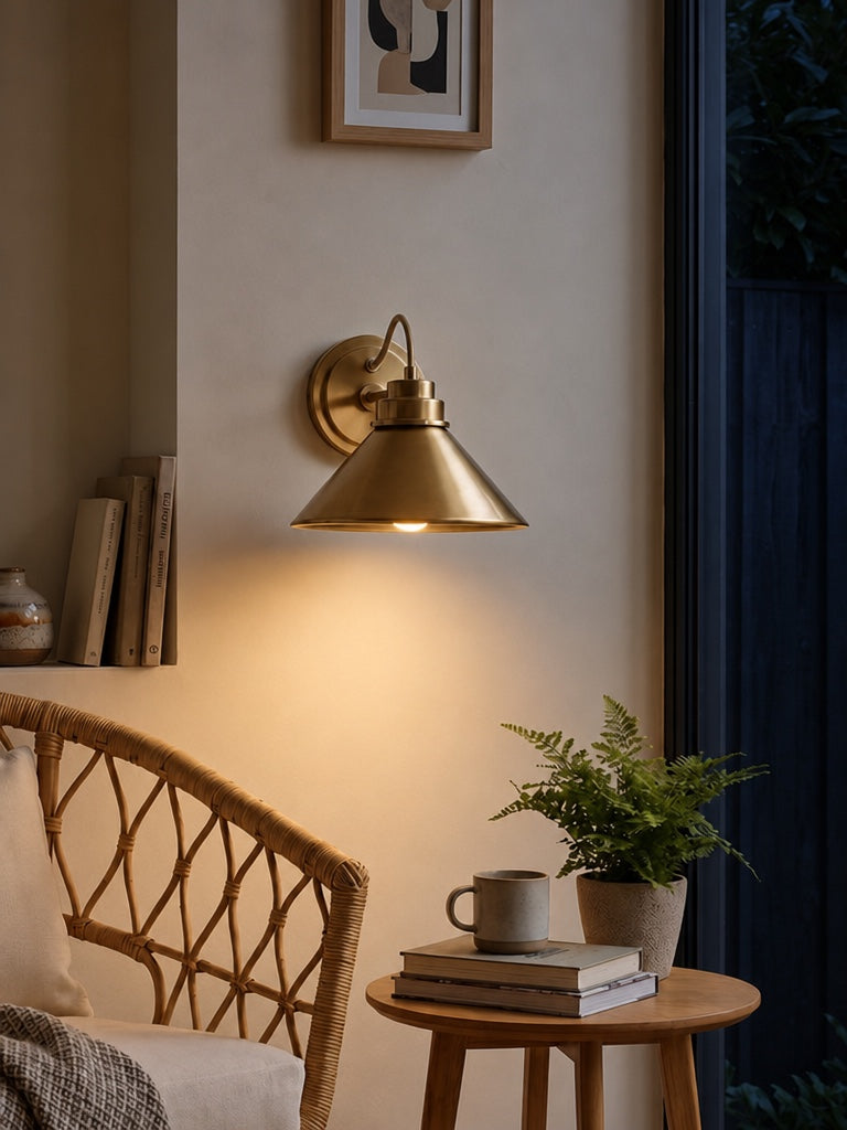 Arvo Bronze Cone Wall Light glowing at dusk, rope-wrapped flex looped over the backplate