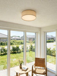 Duma flax drum flush mount ceiling light in a bright garden room by day