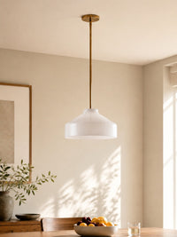 Hano ivory pendant light hanging over a dining table in daylight