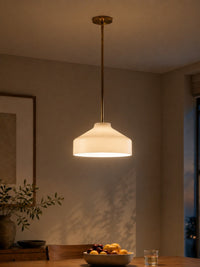 Hano ivory pendant light lit above a dining table in the evening