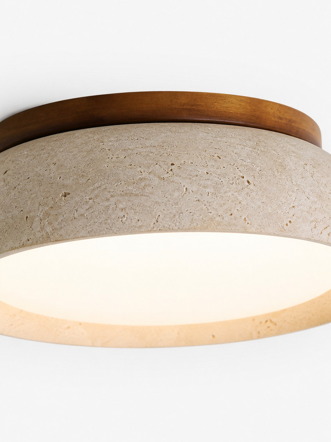 Close up of the travertine stone texture and wood rim on the Trava ceiling light