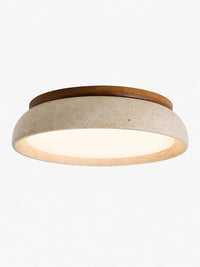Trava travertine flush mount ceiling light with walnut wood rim on a plain background