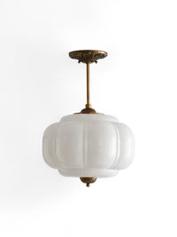 Elva scalloped milk glass ceiling light with brass finish on a white background