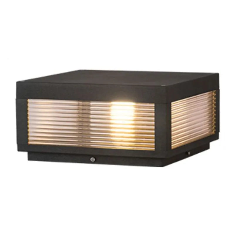 Sentry outdoor column cap light illuminated with warm glow plain background